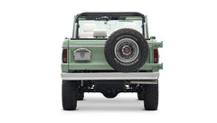 Rear view of a mint green Classic Ford Bronco with spare tire mounted on tailgate