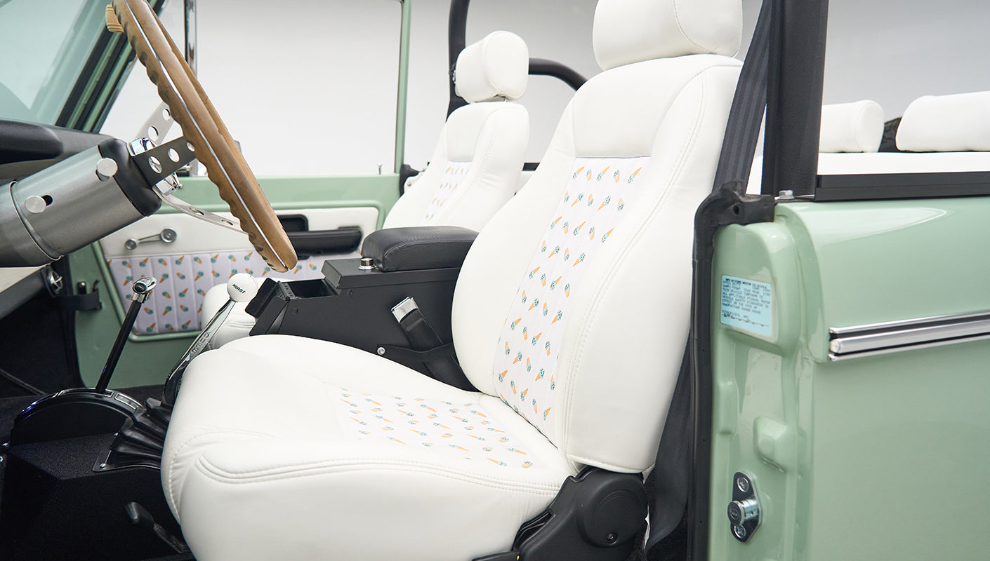 White seats with pineapple pattern inside the mint green Classic Ford Bronco
