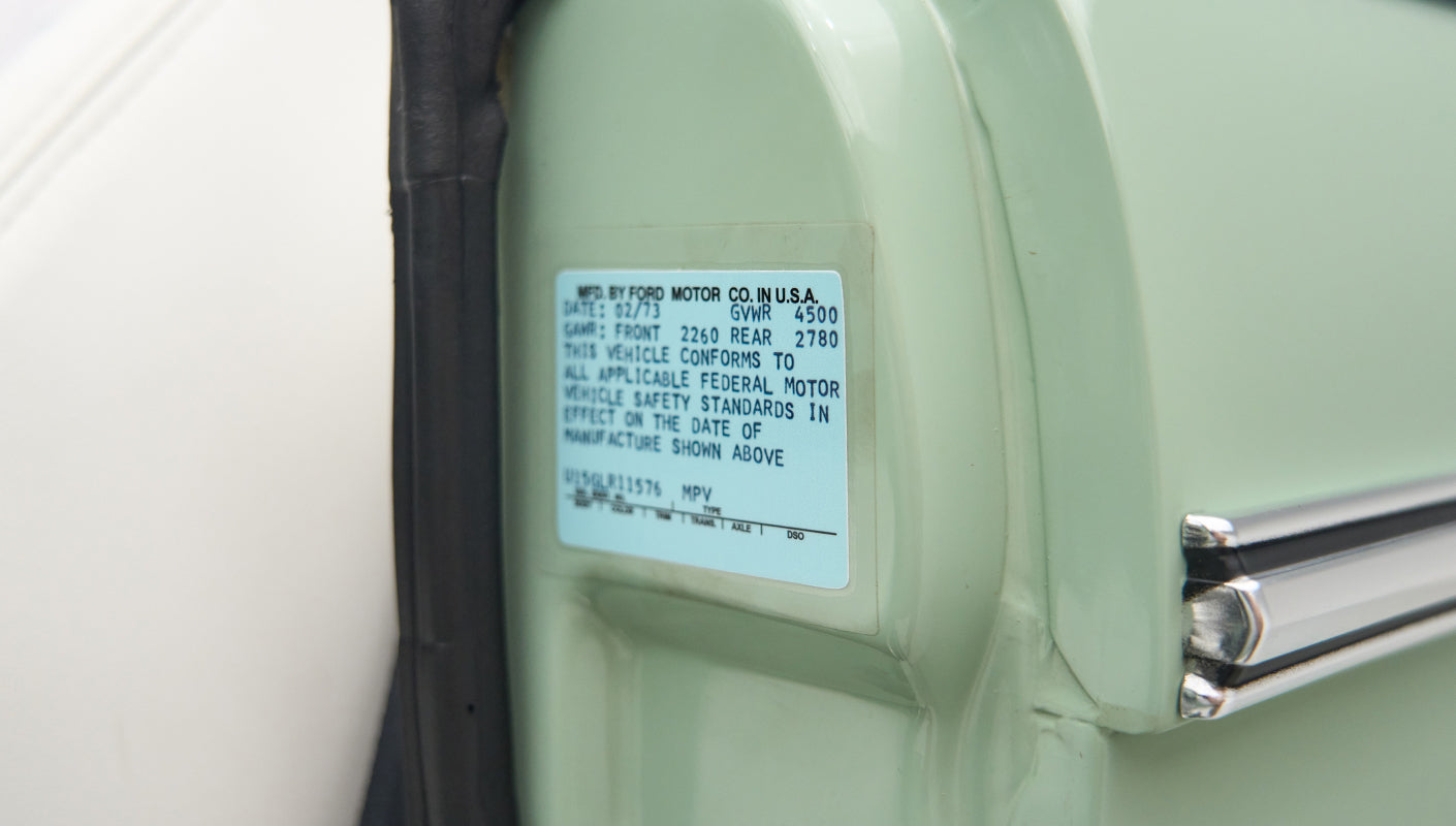 Federal motor vehicle safety standards label on inside edge of Classic Ford Bronco driver's door