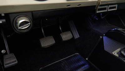 Classic Ford Bronco interior foot pedals with 'Bronco' logo on brake and clutch pedals