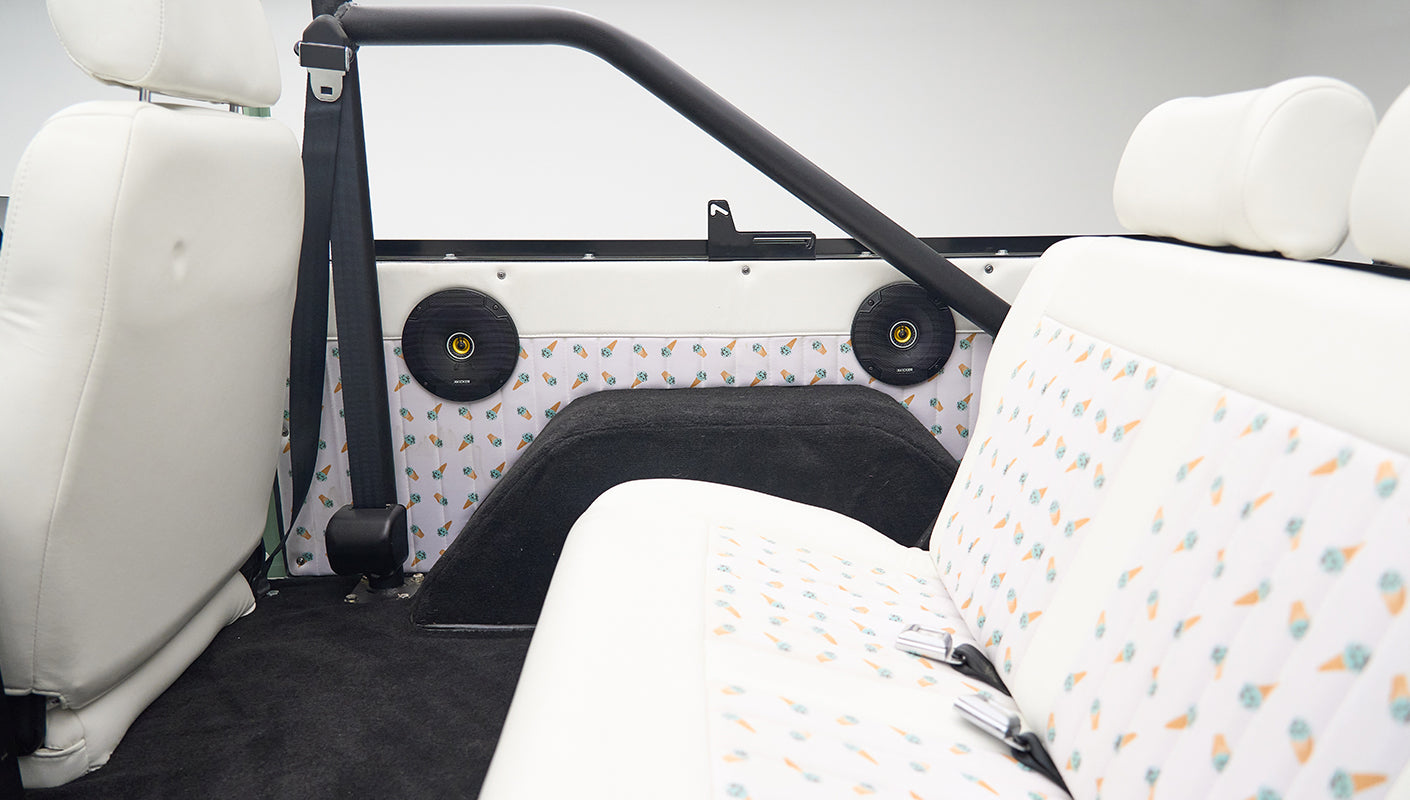 Classic Ford Bronco back seat and interior side panel with ice cream cone patterned upholstery and black speakers