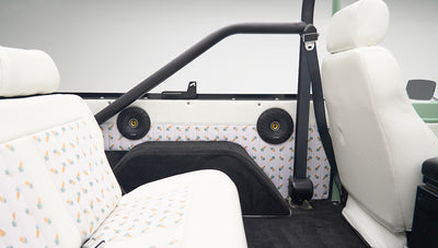Classic Ford Bronco interior showing rear seats with ice cream cone pattern and seat belt buckles