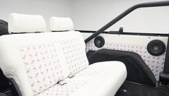 Classic Ford Bronco rear seat with ice cream cone patterned upholstery and black speakers