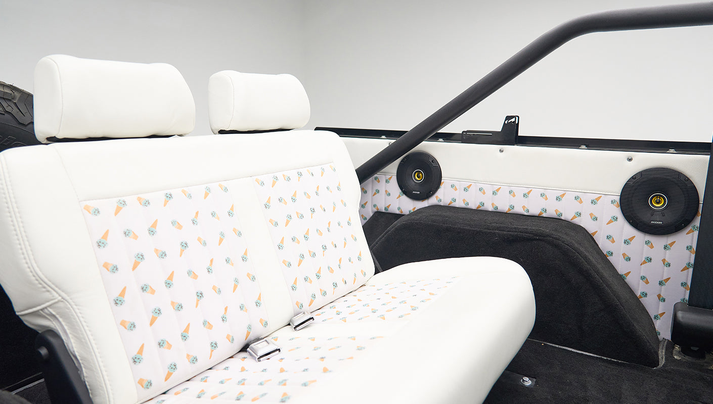 Classic Ford Bronco rear seat with ice cream cone patterned upholstery and black speakers