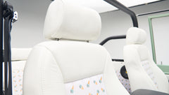White leather seats with an ice cream cone pattern inside a Classic Ford Bronco