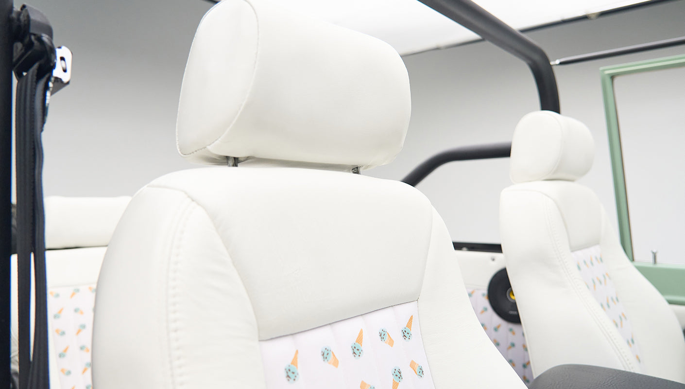White leather seats with an ice cream cone pattern inside a Classic Ford Bronco