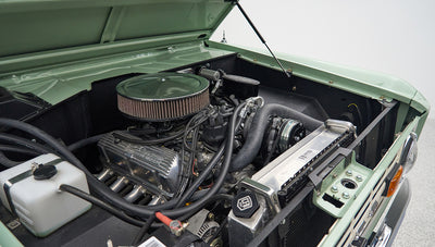 Engine bay of a Classic Ford Bronco with air filter and various engine components