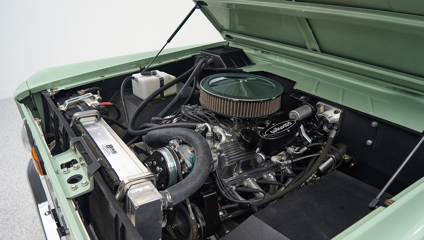 Engine bay close-up of Wilwood brake master cylinder inside a Classic Ford Bronco