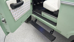 Step plate on green Classic Ford Bronco under open driver door