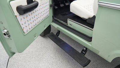 Step plate on green Classic Ford Bronco under open driver door