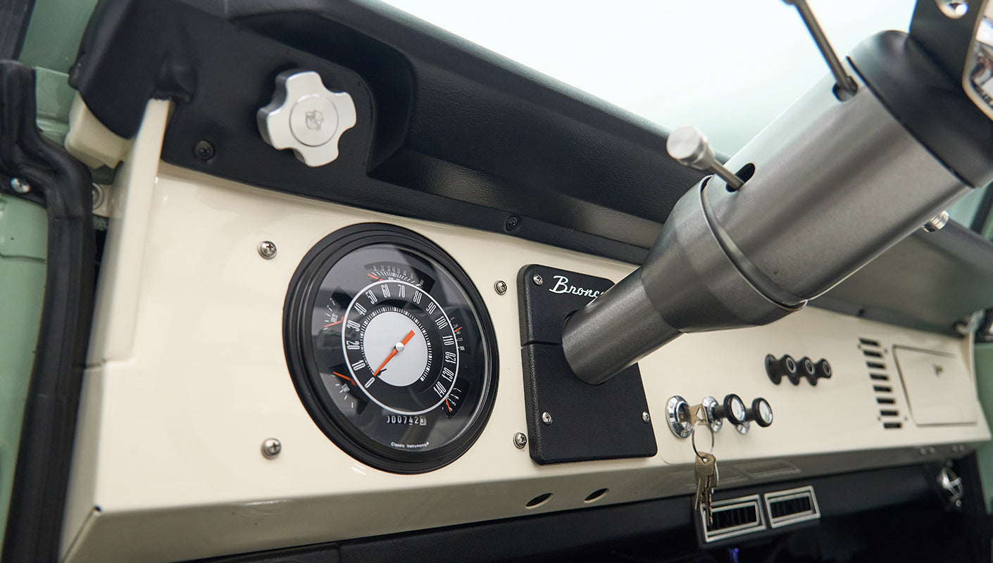 Classic Ford Bronco dashboard with speedometer and Bronco badge