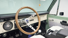 Classic Ford Bronco steering wheel with wooden rim and dashboard