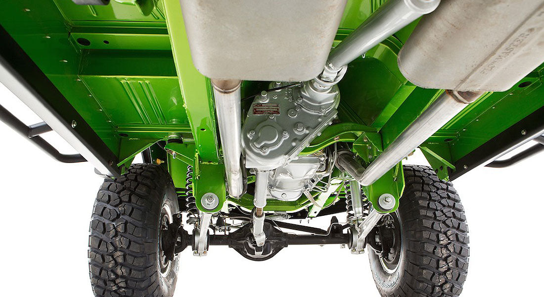 Underside of bright green Classic Ford Bronco showing suspension and exhaust system