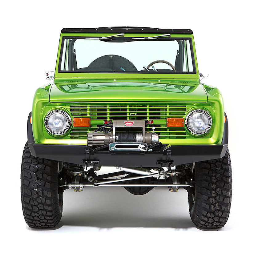 Front view of bright green Classic Ford Bronco with winch and rugged tires on white background