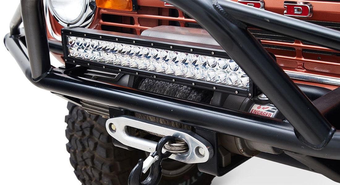 Black LED light bar mounted on front bumper of Classic Ford Bronco with orange grille