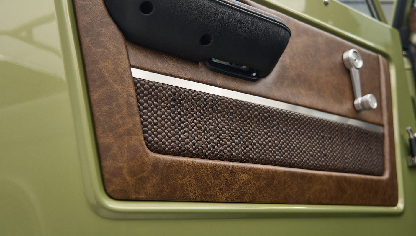 Closeup of brown textured and leather door panel on Classic Ford Bronco