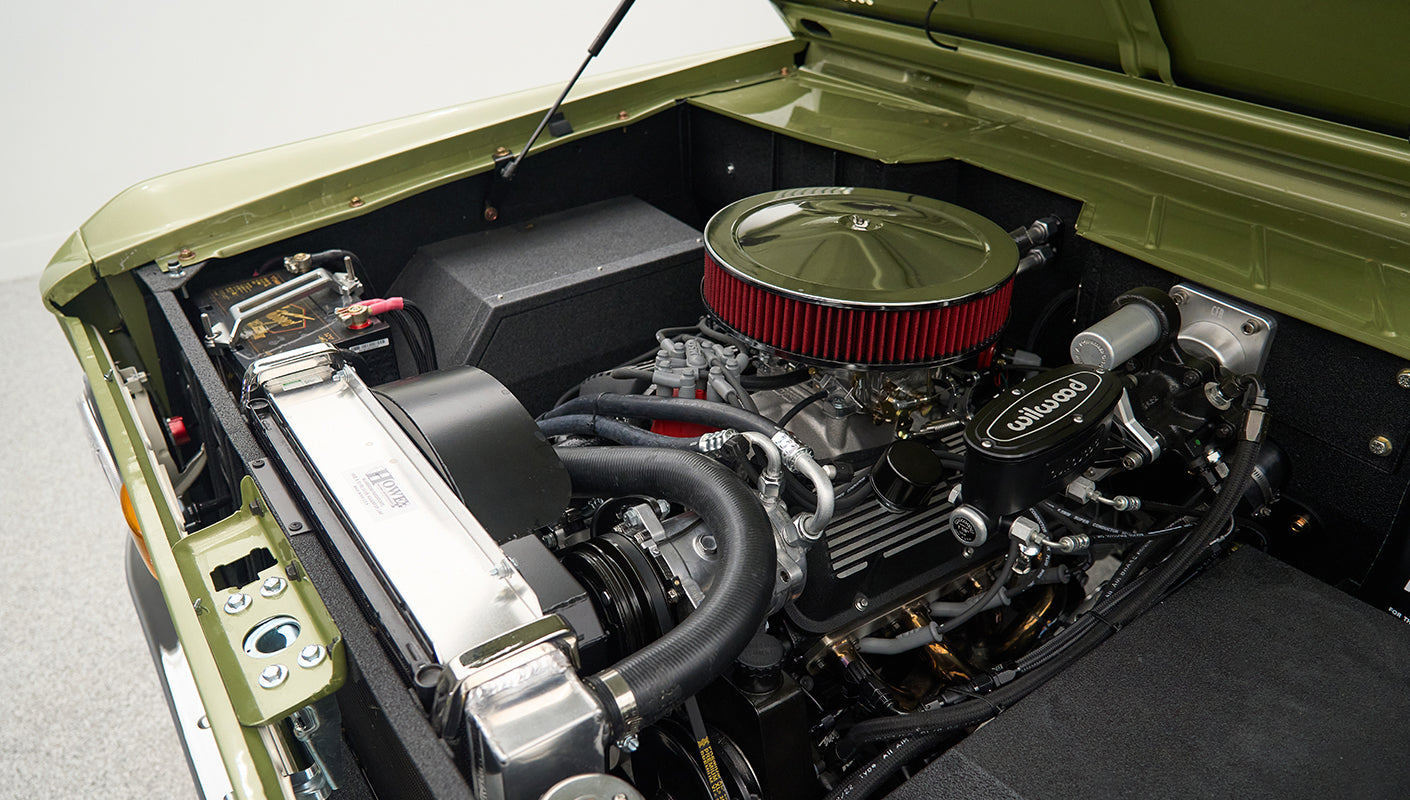 Side view of Classic Ford Bronco engine with radiator and hoses visible