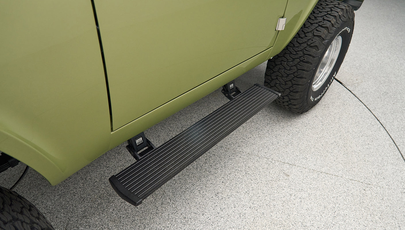 Side step on Classic Ford Bronco next to rear tire with visible tread