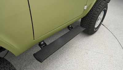 Side step on Classic Ford Bronco next to rear tire with visible tread