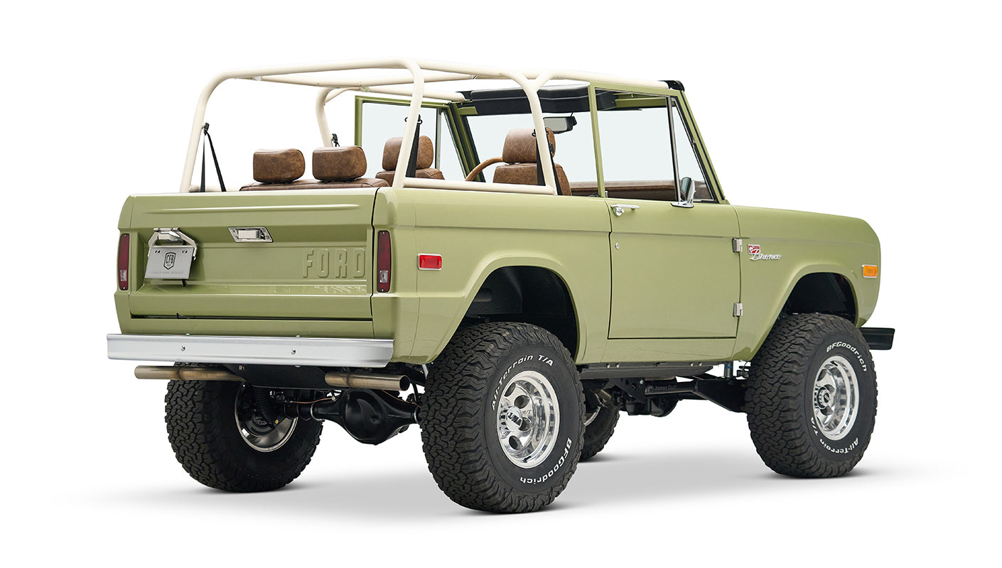 Rear three-quarter side view of lime green Classic Ford Bronco with lifted suspension and tan interior