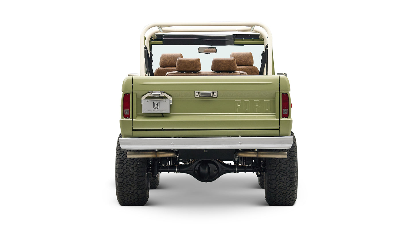 Rear view of lime green Classic Ford Bronco showing tailgate, lights, and exhaust