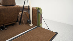 Rear cargo area of Classic Ford Bronco with brown upholstery and beige roll cage