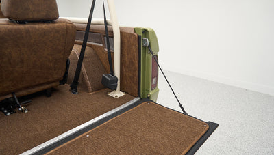 Rear cargo area of Classic Ford Bronco with brown upholstery and beige roll cage