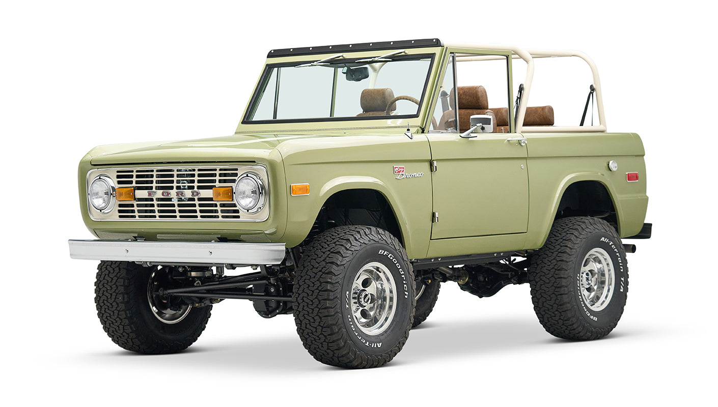 Front three-quarter view of lime green Classic Ford Bronco with lifted tires and open top