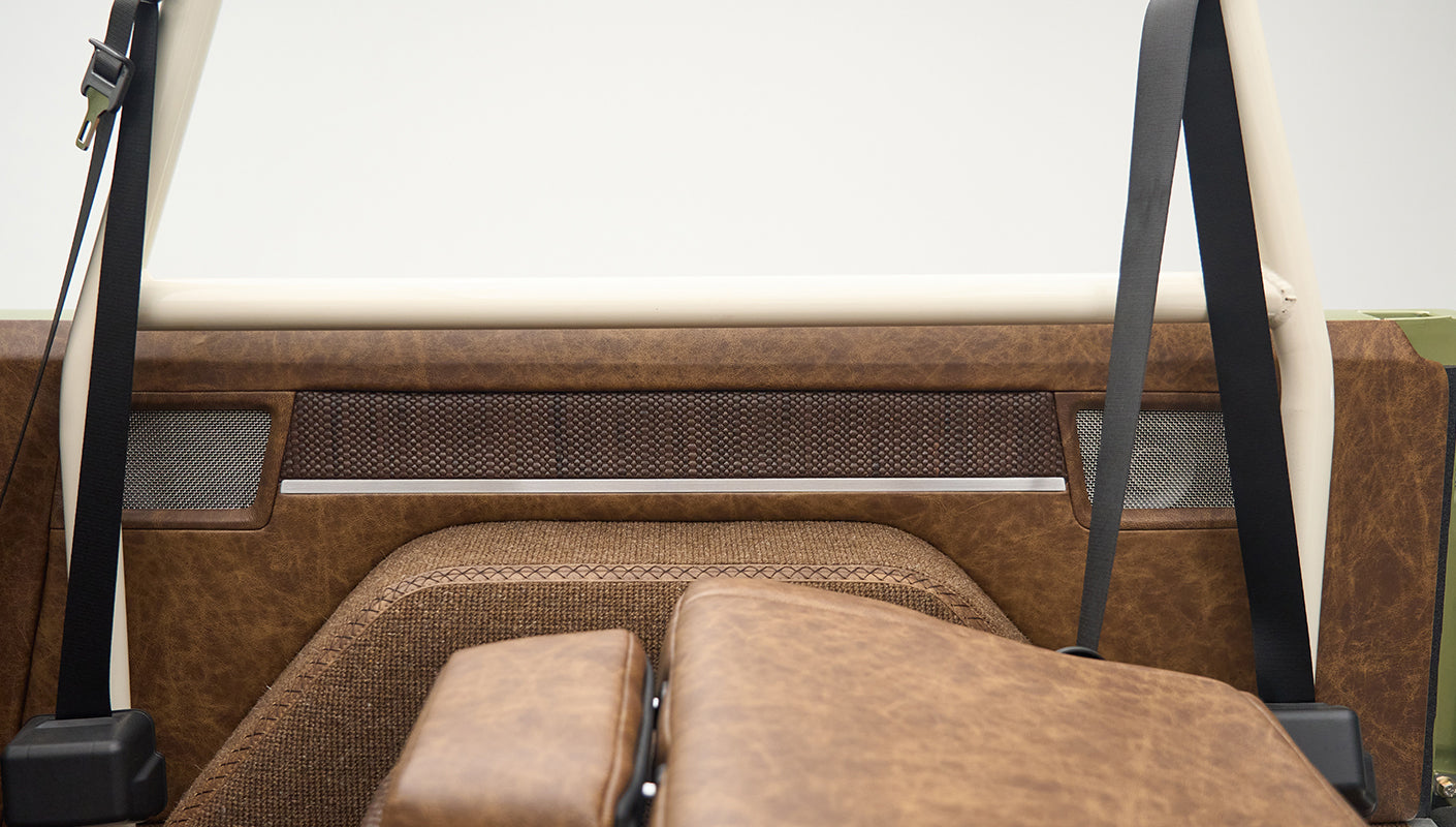 Close-up of brown upholstered interior side panel and seatbelt in Classic Ford Bronco