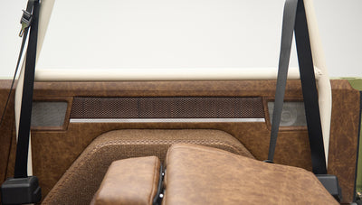 Close-up of brown upholstered interior side panel and seatbelt in Classic Ford Bronco