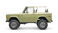 Side view of lime green Classic Ford Bronco with open top and large off-road tires