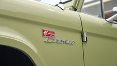 Close-up of Classic Ford Bronco Lime Gold emblem on vehicle side