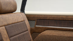 Close-up of brown textured upholstery on the interior side panel and seat of Classic Ford Bronco