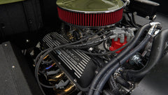 Engine detail with 'Bronco Powered by Ford' on valve cover and red ignition wires