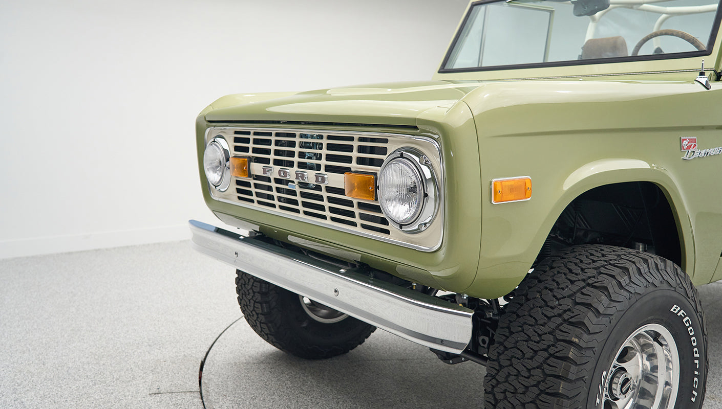 Front end with grille, headlights, amber lights and Ford logo on Classic Ford Bronco Lime Gold
