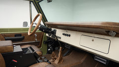Interior of Classic Ford Bronco with brown textured leather seats and lime green door panel