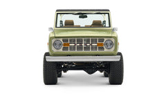 Front view of lime green Classic Ford Bronco showcasing grille, headlights, and bumper