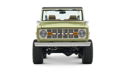 Front view of lime green Classic Ford Bronco showcasing grille, headlights, and bumper