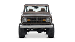 Front view of matte brown Classic Ford Bronco with round headlights and steel bumper