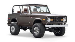 Classic Ford Bronco front-angle view showing lifted suspension and matte brown finish