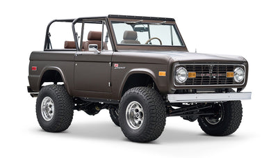 Classic Ford Bronco front-angle view showing lifted suspension and matte brown finish