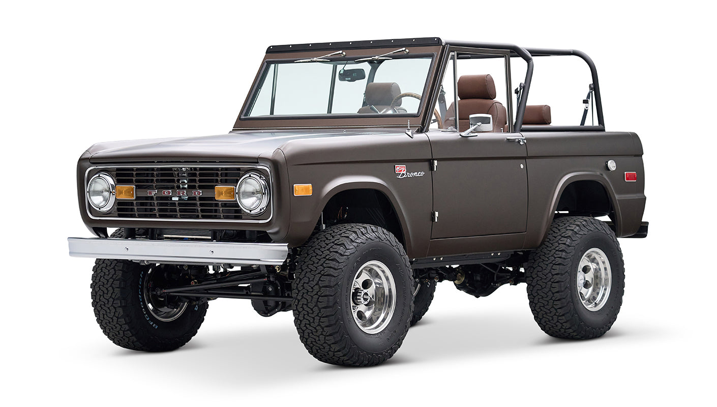 Classic Ford Bronco angled front view with matte brown paint and prominent grille