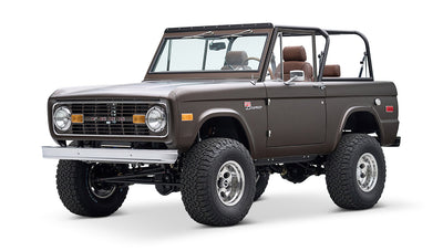 Classic Ford Bronco angled front view with matte brown paint and prominent grille