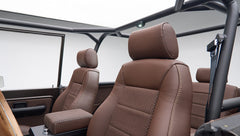 Driver and passenger seats inside Classic Ford Bronco, matte brown leather and fabric upholstery