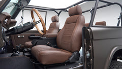 Classic Ford Bronco front passenger seat area with brown leather seats and open side