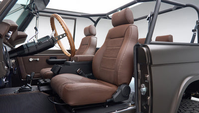 Classic Ford Bronco front passenger seat area with brown leather seats and open side