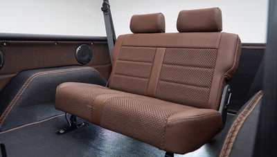 Rear bench seat with brown leather and fabric upholstery in Classic Ford Bronco interior