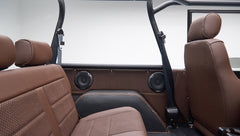 Back seats and side panels with speakers and seat belts inside Classic Ford Bronco in matte brown color