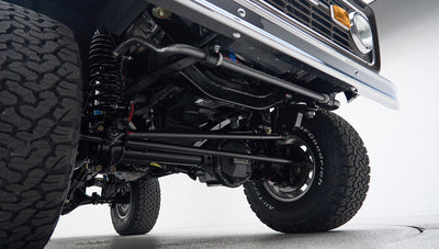 Underneath front suspension and steering components of Classic Ford Bronco with BFGoodrich tires