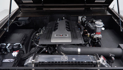 Close-up of Classic Ford Bronco engine bay with 5.0 emblem on engine cover